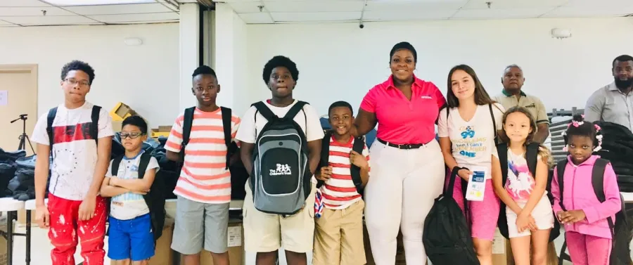 AFSCME Florida President Vicki Hall with Miami students receiving new pack packs and supplies